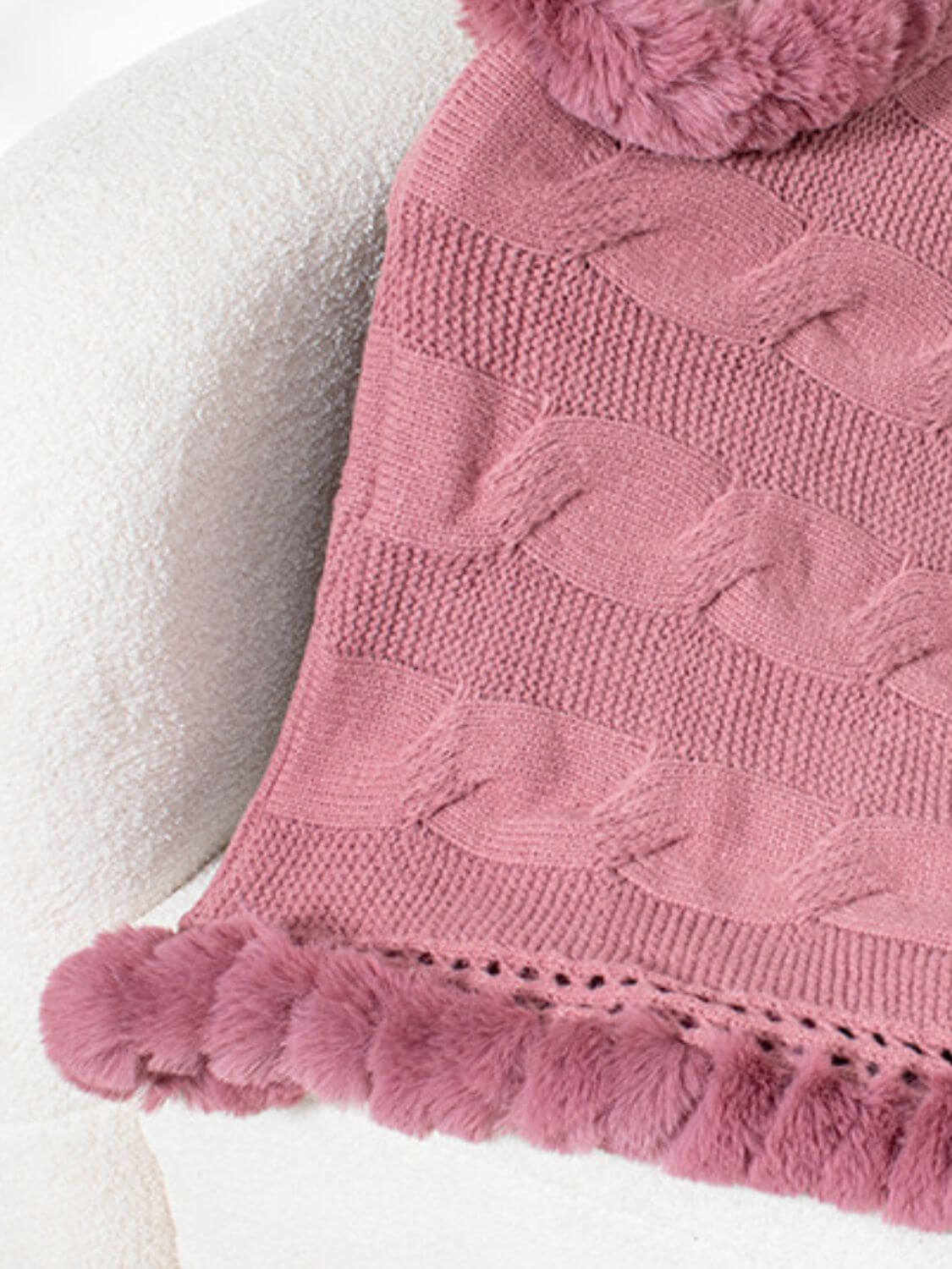 Cozy Bella Road Fuzzy Hem Cable-Knit Poncho in Dusty Pink, showcasing soft texture and stylish pom-pom trim.