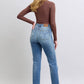 Model in Judy Blue vintage wash thermal straight jeans with pockets and brown long-sleeve top, showcasing a back view.