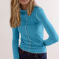 Model wearing a blue Basic Bae contrast trim mock neck long sleeve t-shirt with scalloped edges.