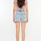 Model from behind showcasing Kancan distressed high-waist denim shorts with pockets and a raw hem.