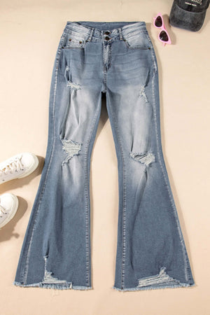 Distressed raw hem bootcut jeans with slightly stretchy material, perfect for stylish casual wear, displayed with white sneakers and pink sunglasses.