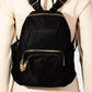 Stylish black nylon multi pocket backpack with gold zippers, perfect for organization on any adventure.