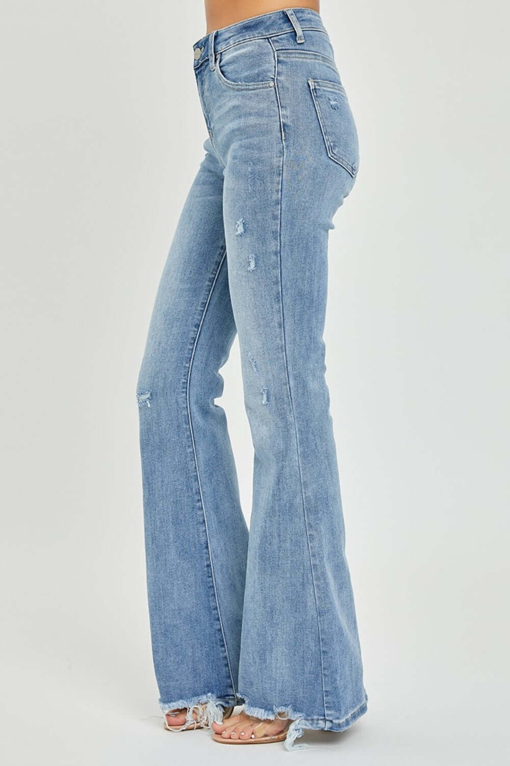 High Rise Frayed Hem Flare Jeans by Risen Jeans, featuring a flattering high-rise waist, trendy frayed hem, and retro-inspired flare leg design.