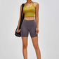 Model wearing Millennia high-waist training shorts and crop top, showcasing comfort and style for gym and casual wear.