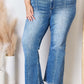 Woman modeling Risen Jeans high rise ankle flare jeans with quality stitching and flattering fit.