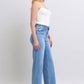 Model showcasing Judy Blue full-size wide leg jeans with pockets, styled for a chic and trendy look.