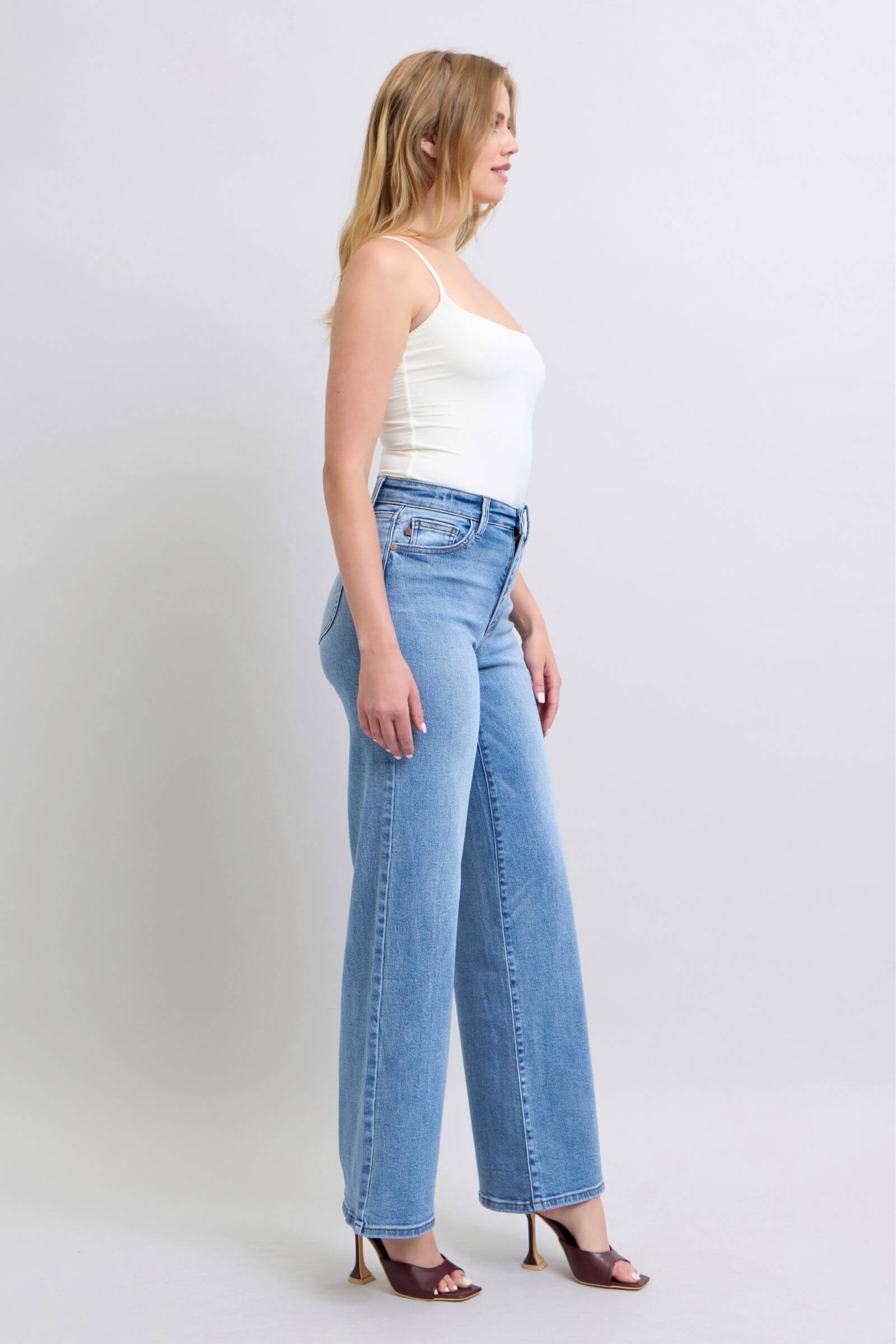 Model showcasing Judy Blue full-size wide leg jeans with pockets, styled for a chic and trendy look.