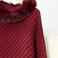 Cozy Bella Road fuzzy trim poncho in burgundy with textured fabric and three-quarter sleeves hanging on a wooden hanger.