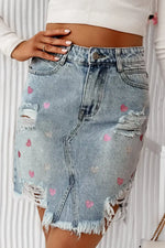 Bella Road distressed denim skirt with raw hem and heart designs, perfect for a cute and edgy look.