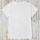 Back view of white graphic round neck short sleeve t-shirt made of 100% polyester, lying on wooden surface.