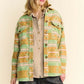 Model wearing a stylish High-Low Geometric Long Sleeve Shacket with pockets, showcasing a vibrant green and orange pattern.