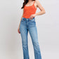 Model wearing Judy Blue high waist tummy control vintage wash bootcut jeans with orange tank top and stylish side slit.