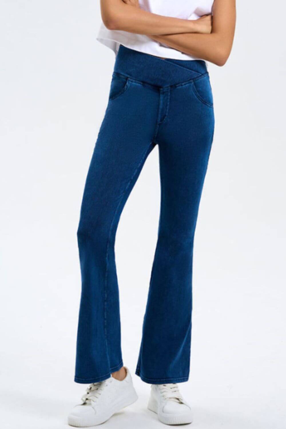 Model showcasing Basic Bae Bootcut Jeans in blue, highlighting stretchy fabric and stylish pocketed design.