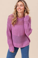 Woman wearing BiBi Openwork Long Sleeve Knit Top in lilac with jeans, showcasing intricate knit design and casual style.