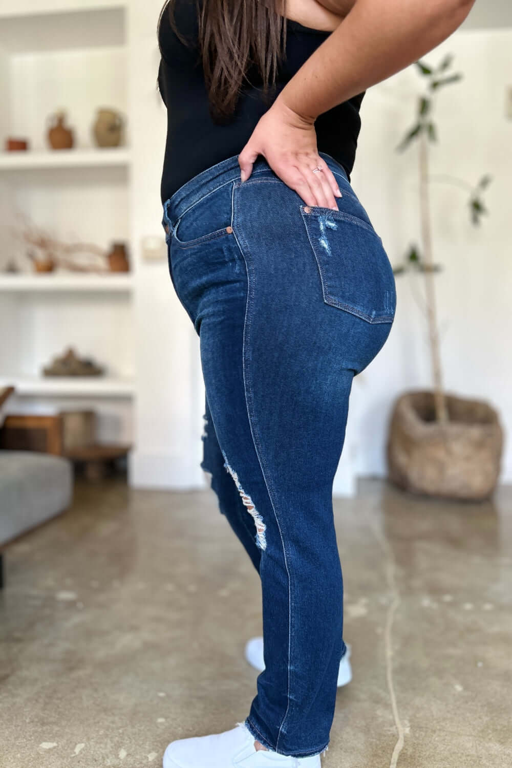 Side view of person wearing High Waist Rigid Magic Heavy Destroy Straight Judy Blue Jeans.