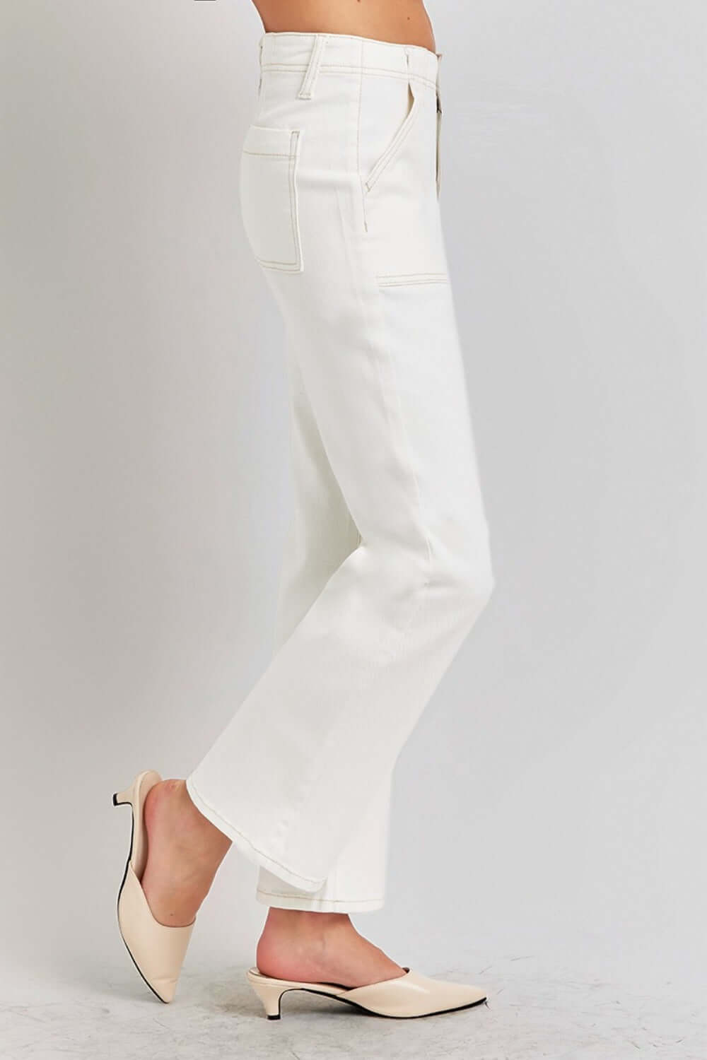 White high-rise ankle flare jeans with patch pockets and chic silhouette, paired with beige heels for a retro and flattering look.