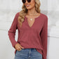 Woman wearing Bella Road Waffle-Knit Notched Long Sleeve T-Shirt in red, paired with blue jeans and sunglasses, casual stylish look.