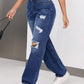 Distressed jeans with pockets featuring edgy rips, worn by woman. Style and function in denim, 85% cotton, 15% polyester.