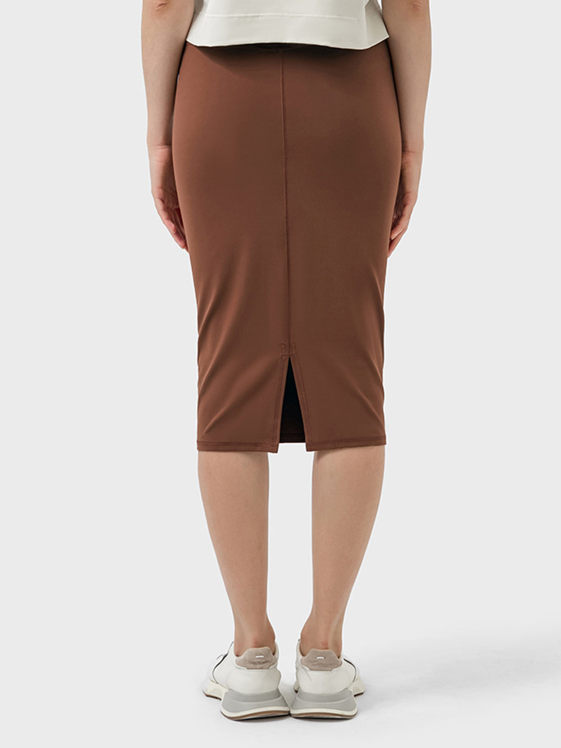 Back view of the Millennia Slit Wrap Active Skirt in brown, showcasing its stylish slit detail and stretchy fit.