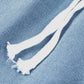 Close-up of white drawstring on light wash denim fabric for stylish cargo pocket jeans.