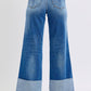 Back view of Judy Blue distressed high waist wide leg jeans showcasing relaxed fit and stylish cuffed hems.