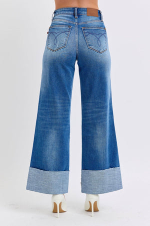 Back view of Judy Blue distressed high waist wide leg jeans showcasing relaxed fit and stylish cuffed hems.