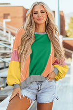 Woman wearing Bella Road Color Block Round Neck Long Sleeve Top and denim shorts outdoors