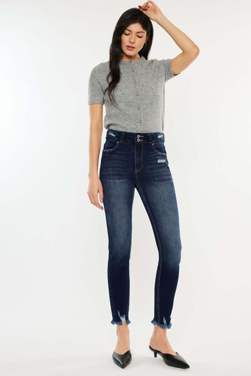 Woman wearing Cat's Whiskers Raw Hem High Waist Jeans with grey top and black flats, showcasing the edgy vintage-inspired style.