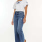 Woman wearing Kancan full size high rise slim wide leg jeans with unique hem, styled with a white embroidered top and sandals.