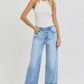 Model wearing RISEN full size ankle wide leg cuffed jeans paired with a fitted white tank top.