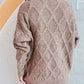 Woman wearing Bella Road Diamond Round Neck Long Sleeve Sweater with unique diamond pattern from back view.