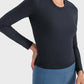 Model showcasing the Millennia Round Neck Long Sleeve Sports Top in black, perfect for workouts or lounging.