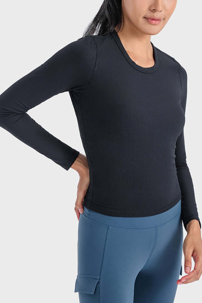 Model showcasing the Millennia Round Neck Long Sleeve Sports Top in black, perfect for workouts or lounging.