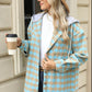 Woman wearing Bella Road Drawstring Plaid Long Sleeve Hooded Jacket holding coffee cup