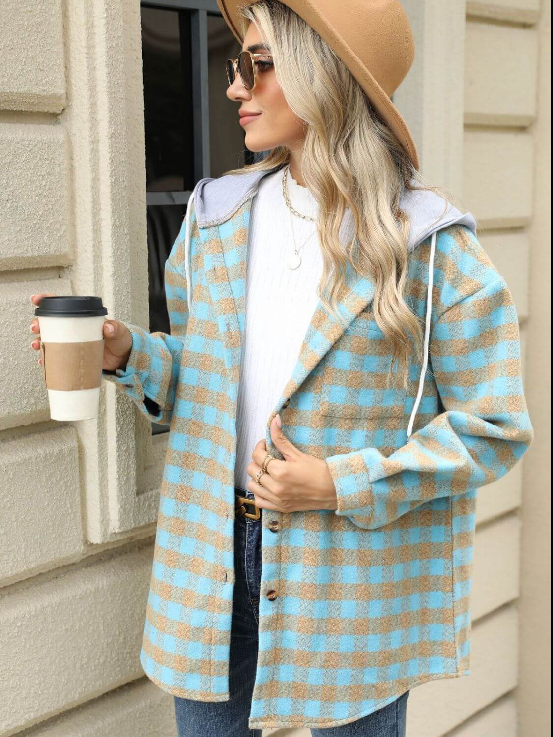 Woman wearing Bella Road Drawstring Plaid Long Sleeve Hooded Jacket holding coffee cup