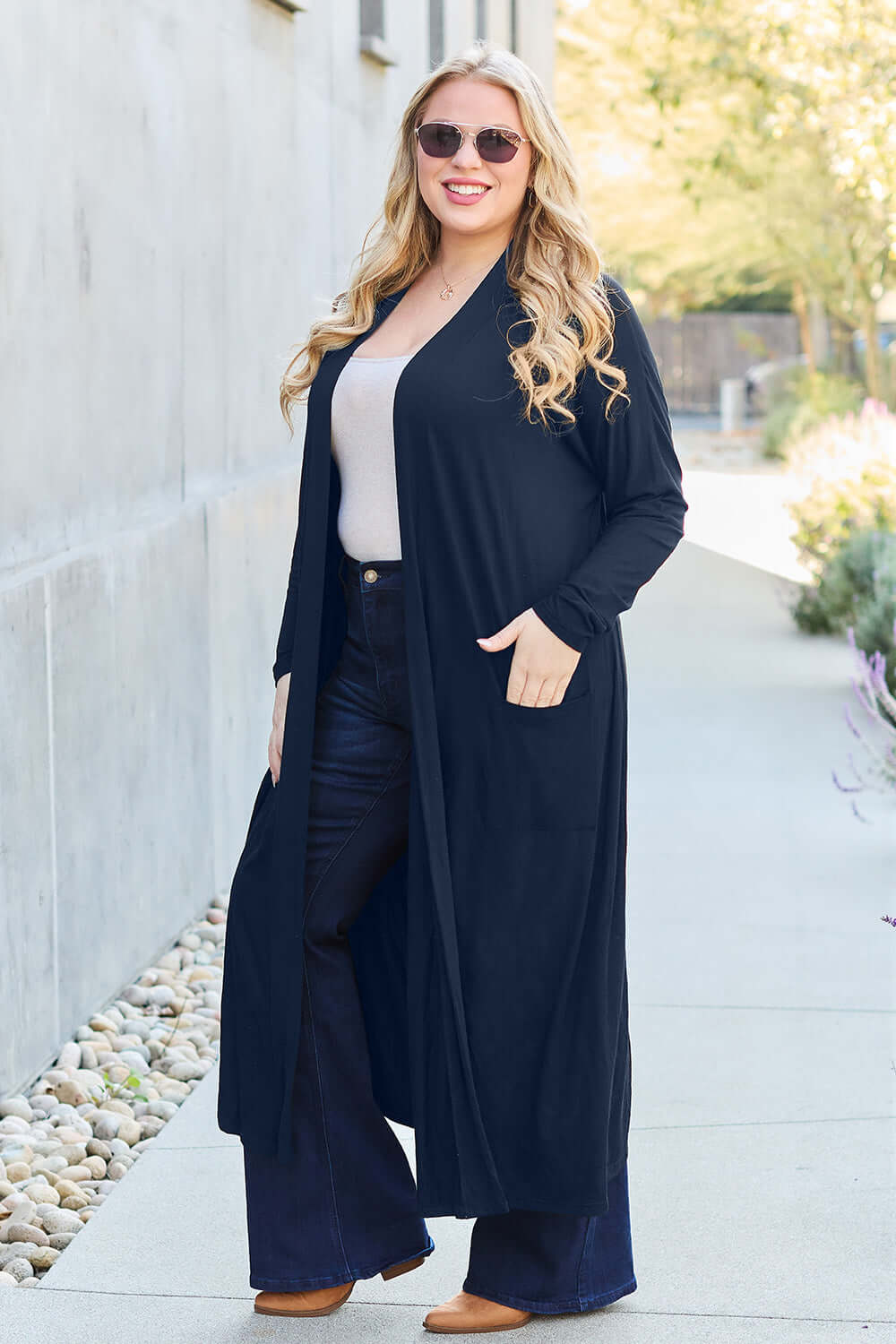 Woman wearing Open Front Long Sleeve Cover Up with pockets, slightly stretchy, 95% rayon and 5% spandex, outdoors in a casual setting