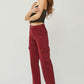 Woman modeling RISEN full size high rise wide leg cargo jeans in red, showcasing a fashionable and functional casual outfit.