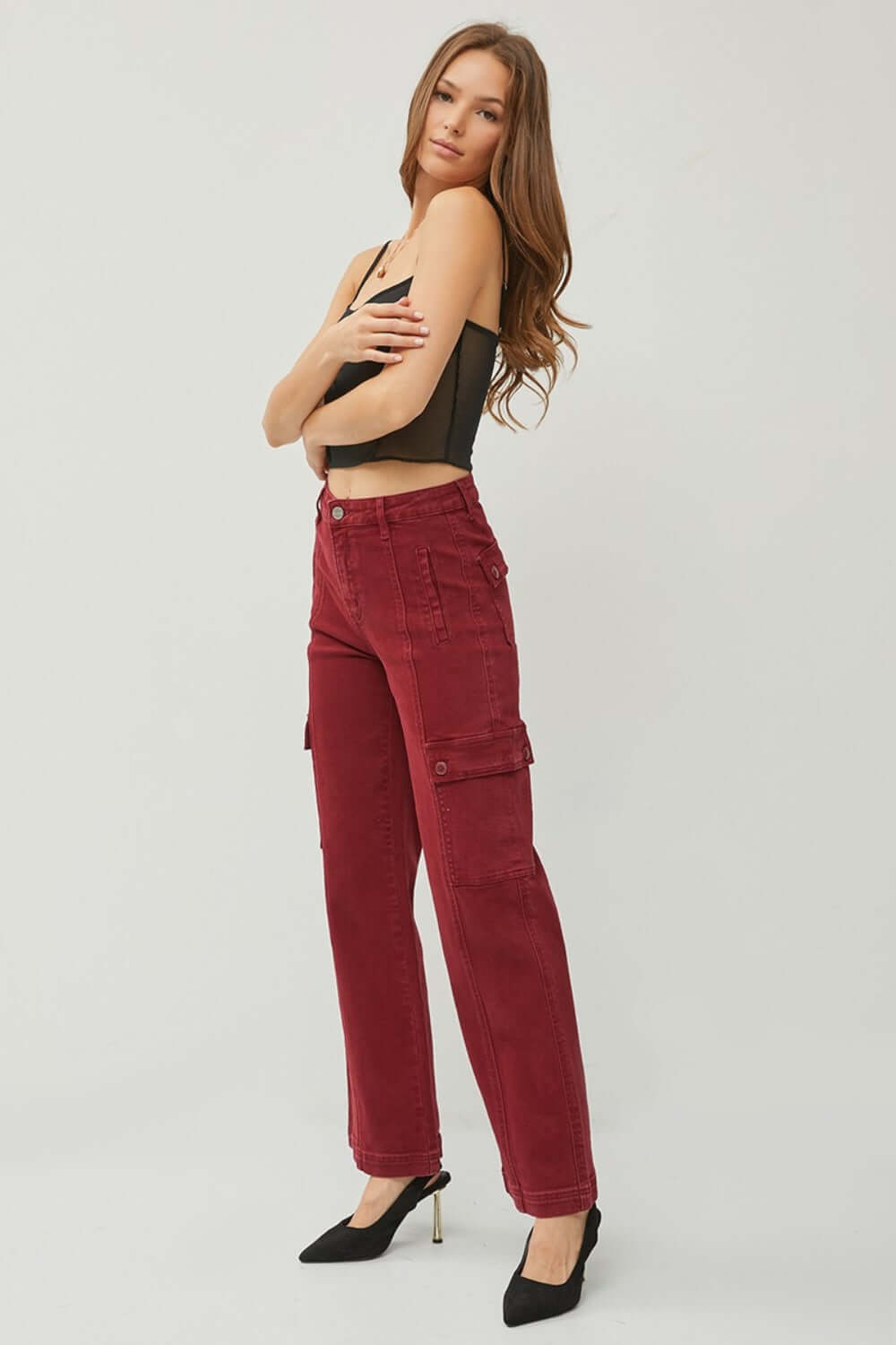 Woman modeling RISEN full size high rise wide leg cargo jeans in red, showcasing a fashionable and functional casual outfit.