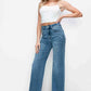 Young woman showcasing bytos full size high rise wide leg jeans with pockets, styled with a trendy white crop top.