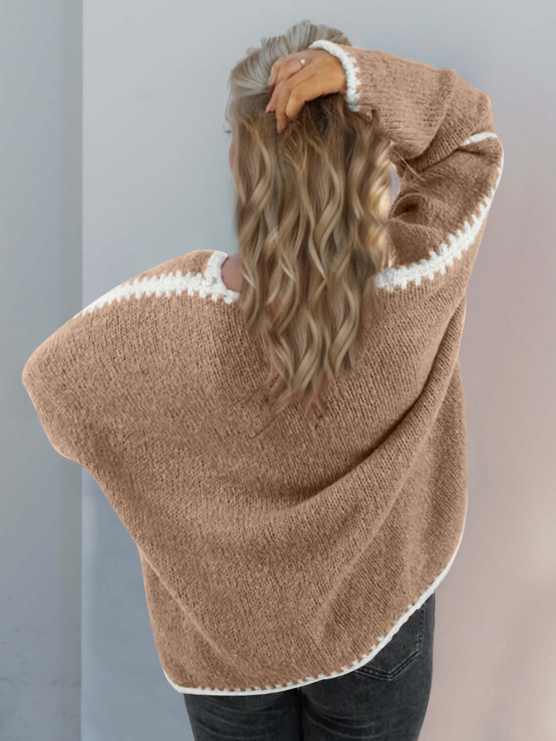 Woman wearing a Double Take Contrast Cardigan with open front and dropped shoulders, showcasing the relaxed back design.