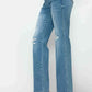 Distressed high rise straight jeans showcasing a flattering fit and edgy rips on a model, perfect for stylish outfits.