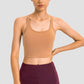 Millennia Racerback Sports Bra in nude, perfect for yoga with removable padding and a sleek design for ultimate style.