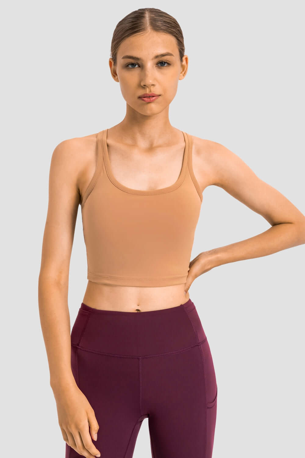 Millennia Racerback Sports Bra in nude, perfect for yoga with removable padding and a sleek design for ultimate style.