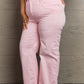 Raelene High Waist Wide Leg Jeans in light pink by Risen Jeans, showcasing flattering fit and retro flair on various body types