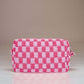 Stylish pink checkered pattern knitted cosmetic pouch with zipper closure, perfect for organizing beauty essentials.