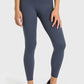 Woman in navy high waist ankle-length yoga leggings, perfect for stylish workouts and yoga sessions.