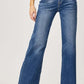 Woman wearing high-rise frayed hem wide leg jeans by Risen Jeans showing off trendy and stylish look for casual outings or dressed-up occasions.