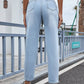 Woman wearing Bella Road Distressed Straight Jeans with pockets, view from behind on sidewalk