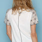 Woman wearing Lace Short Sleeve Exposed Seam T-Shirt with lace detailing on sleeves for a chic and elegant casual look.