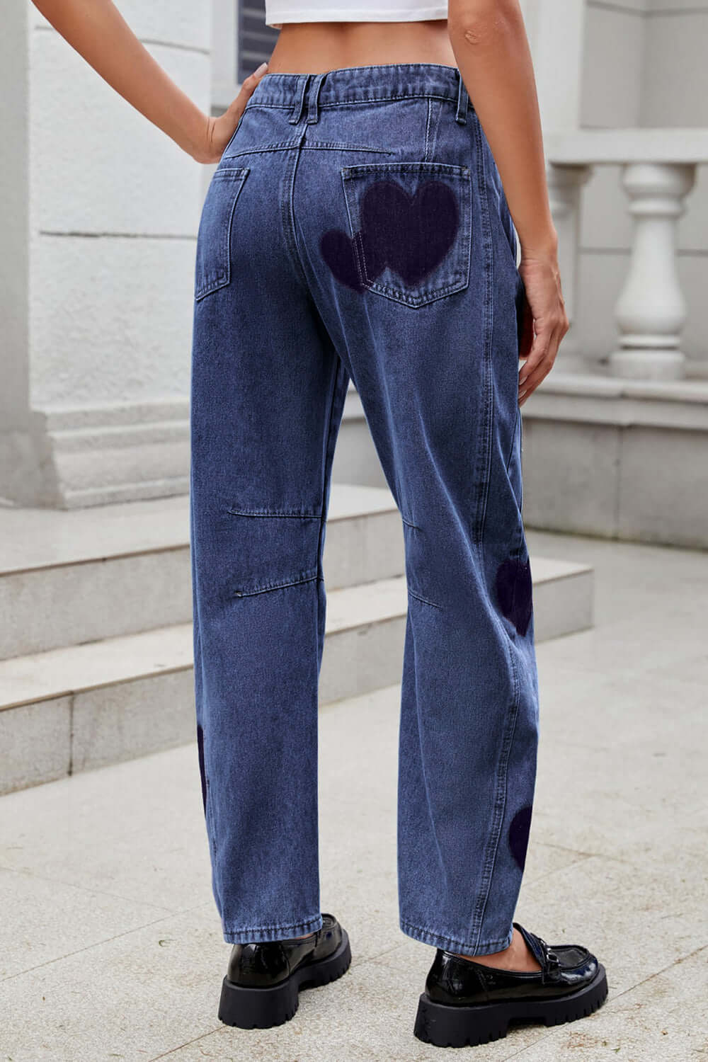 Back view of Bella Road Denim Heart Mid Rise Jeans with whimsical heart design and pockets, perfect for casual style.